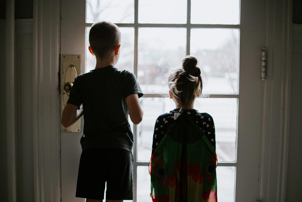 children at window during lockdown